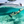 Load image into Gallery viewer, a man and a woman with a boat on the backgroundunder crystalline waters using the Jobe Infinity Seascooter