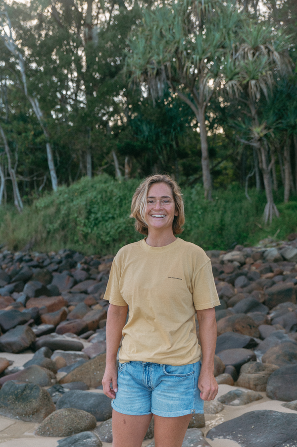 Wolf Bear Collective Origin T-Shirt in yellow colour lifestyle photo on the beach