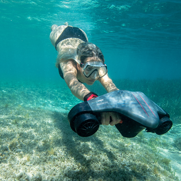 a woman under crystalline waters using the Jobe Infinity Seascooter